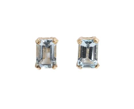 A pair of blue topaz stud earrings, each claw set with a rectangular step cut light blue topaz, 4 x 6mm, to post and butterfl