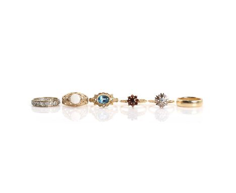 A group of six rings, comprising a wedding ring, stamped 14K, tested as approximately 14ct gold, a 9ct gold opal single stone