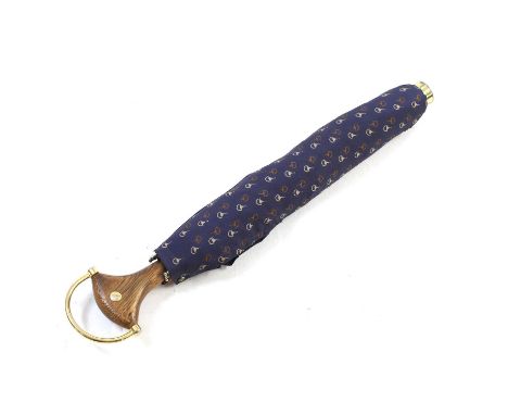 A vintage Gucci Umbrella, c.1980s, the polyester parsol decorated with the Gucci 'horsebit' pattern on a navy blue ground, af