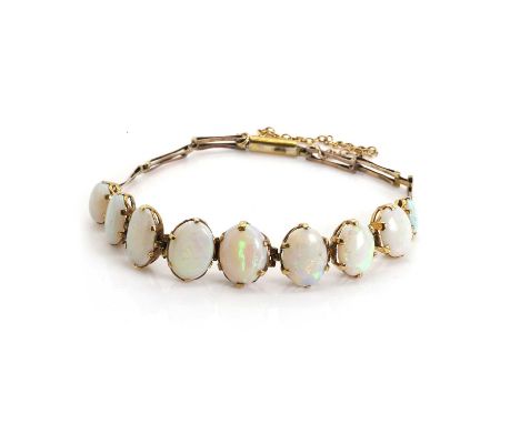An Edwardian graduated opal bracelet, with a graduating line of articulated oval opal cabochons, 6mm to 11mm in size and all 