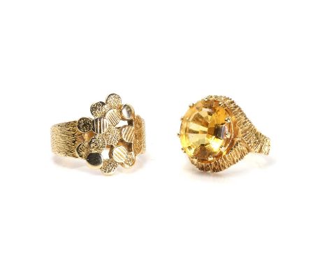 An 18ct gold citrine ring and a 9ct gold ring, with an oval cut citrine, 10mm x 12mm, claw set to a raised textured mount, in