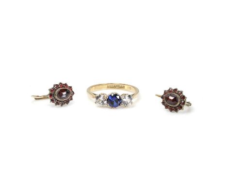 A 9ct gold synthetic sapphire and synthetic colourless spinel ring, claw set to chenier shoulders and a plain band, Birmingha