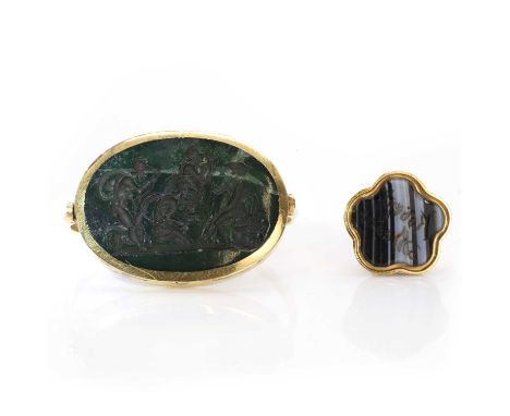 Two hardstone seals, a hardstone intaglio seal,with an oval intaglio, mounted to a hinged faceted band, 25mm x 22mm, the hard