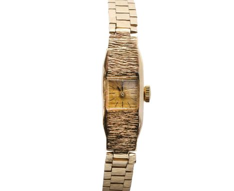 A ladies' 9ct gold mechanical bracelet watch, with an elongated tonneau-shaped bark finish case, a champagne textured dial, b