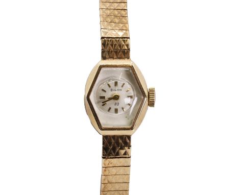 A ladies' 9ct gold Bulova mechanical bracelet watch, ref. M5, with a hexagonal case, a silvered dial, raised gilt batons, gil