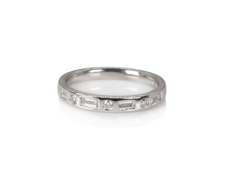 An 18ct white gold diamond half eternity ring,  flush set with baguette cut diamonds spaced with round brilliant cut diamonds