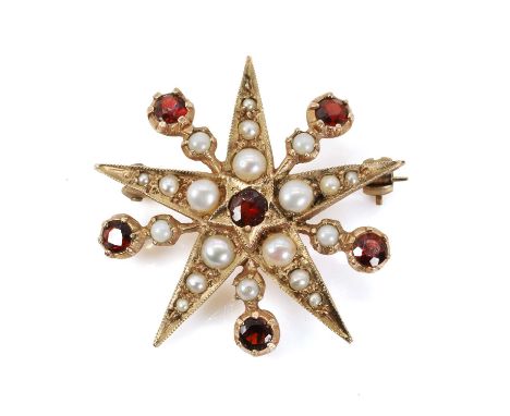 A 9ct gold garnet and split pearl starburst brooch, designed as a five-pointed star, with a central round cut garnet, grain s