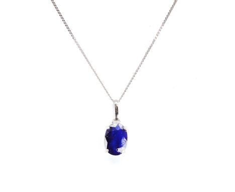 A white gold sapphire single stone pendant, with an oval cut sapphire, 7mm x 5mm, four claw set, to an articulated bale, 10mm