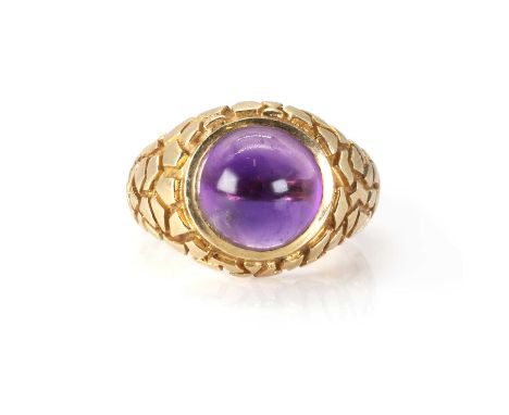 A 9ct gold and amethyst modernist ring, c.1967,  with a circular cabochon amethyst bezel set to a signet style mount, with te