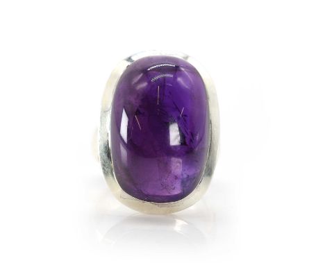A sterling silver amethyst single stone ring,  with a large oval cabochon amethyst, 16.20 x 23.50mm, in rub over setting, to 