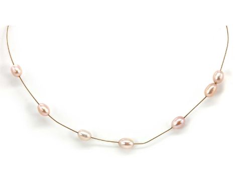 An 18ct gold freshwater pearl wire choker, with seven freshwater pearls, untested, strung to an 18ct gold rope twist wire, wi