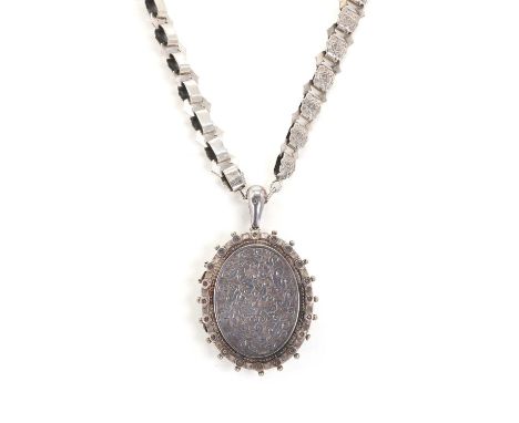 A late Victorian locket pendant, the silver locket pendant, oval in shape, with a central hand engraved panel and applied bea
