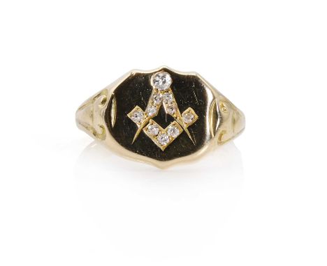 An 18ct gold diamond Masonic signet ring, a shield shaped head with an incised square and compass, grain set with old cut dia