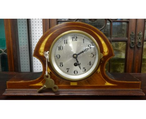 A French mantle clock with mahogany chequered cross banded and inlaid case.
