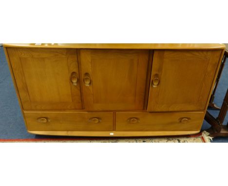 An Ercol light elm sideboard, Ercol plate rack and corner cabinet.