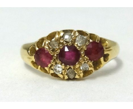 An 18ct gold ruby and diamond fancy cluster ring, finger size L.