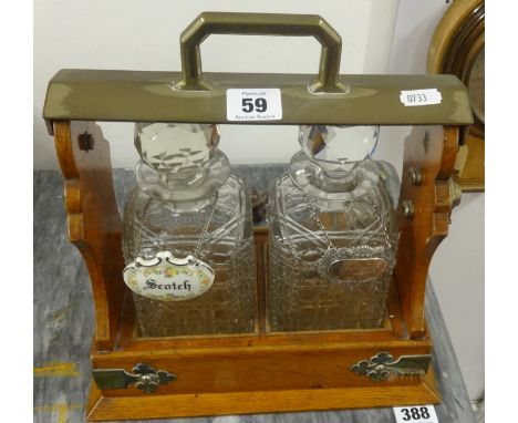 An oak framed two bottle Tantalus.