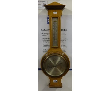A Harrods compensated wheel barometer, in light mahogany case, height 64cm.
