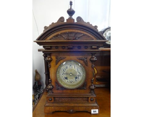 A 9th century German architectural wood cased mantle clock with strike on gong, with key and pendulum.