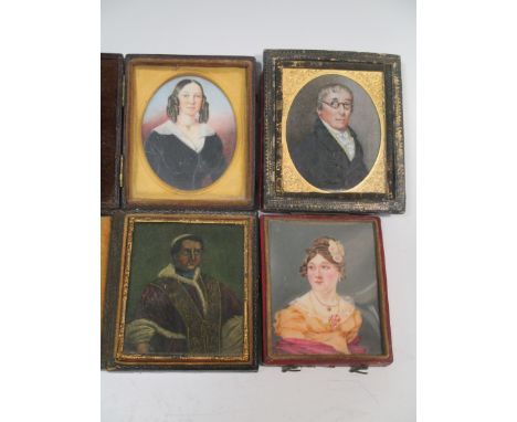 Oval miniature of an old man wearing glasses in a black coat, and three other portrait miniatures in leather 'book' frames (4