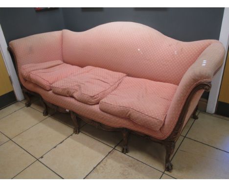 A George II style mahogany three seater sofa, upholstered in a salmon pink fabric on claw and ball feet, 214cm wide  