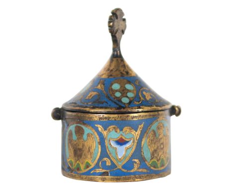 Copper gilt and engraved pyx, with champlevé enamel. Limoges. France. Romanesque. 13th century.11 x 7 cm.In the form of a cyl