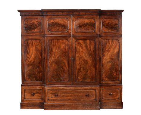 
	
		An early Victorian mahogany wardrobe, circa 1850, of breakfront outline, the moulded cornice above a pair of panelled do