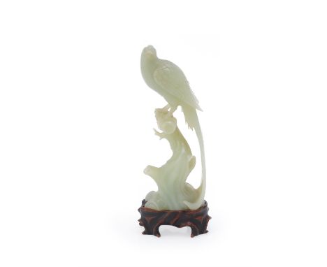 
	
		A Chinese celadon jade model of a pheasant, possibly Republican Period, the jade of of even tone, perched on a tree stum