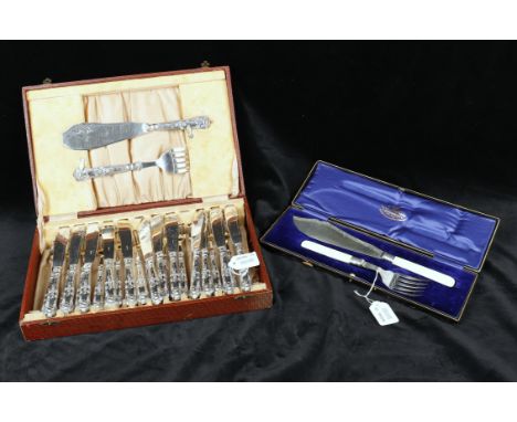 
	
		A cased set of twelve pairs of Kings pattern fish eaters, with loaded silver handles, plated blades and prongs with matc