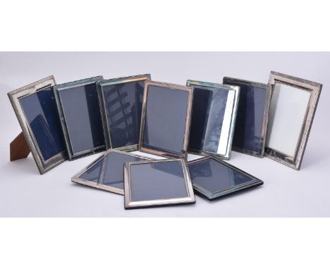 
	
		A collection of electro-plated photo frames, to include: a set of four photo frames, with bead and reel borders, 23.5cm 