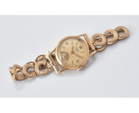 
	
		Norma, 
		Gold coloured wrist watch
		Movement: Swiss manual wind, 17 jewels
		Case: Gold coloured case, snap case back,