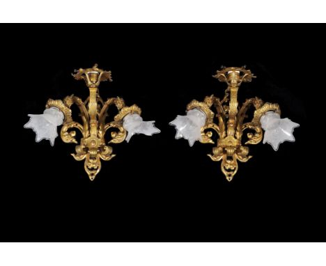 
	
		A pair of gilt brass three light wall lights, each with foliate branches and glass shades, 41cms wide, 34cms high; and t