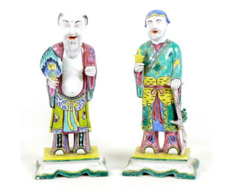 Two Chinese porcelain polychrome figures, likely early 20th century, each modelled as a deity, one of a sage in a green decor