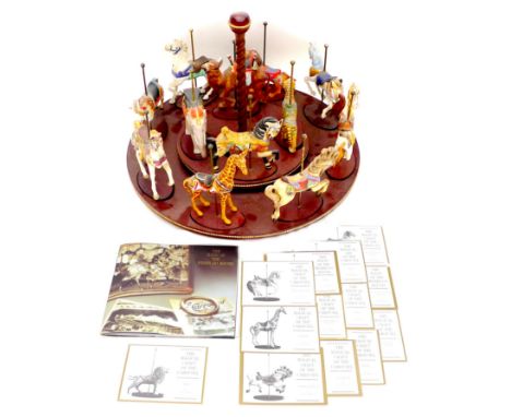 A Franklin Mint 'Magic of the Merry-Go-Round' carousel, with twelve William Manns designed carousel animals, including 'Armou