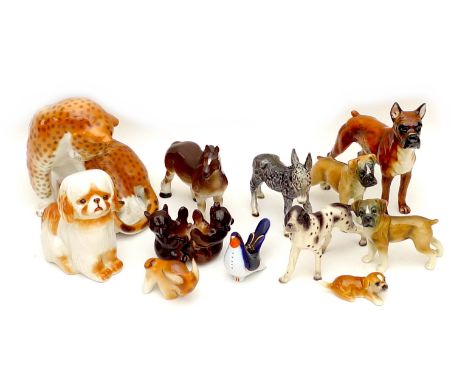 A collection of West German and Russian china figurines, all modelled as animals, including a Lomonosov leopard, 21 by 16 by 