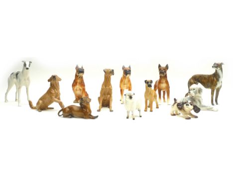 A collection of ceramic animal figurines, all modelled as dogs, some marked, including two Goebel, one Royal Belvedere Vienna
