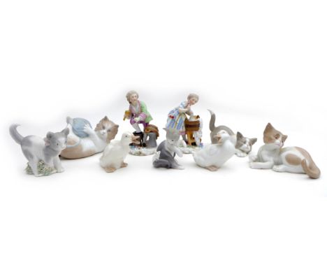 Two Rockingham style figurines, a washer woman,10 by 7 by 14cm high, 8 by 8 by 15cm high, and a cooper together with a group 