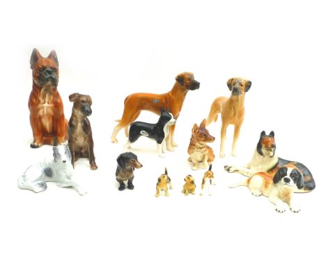 A collection of ceramic figurines, all modelled as dogs, including a Sylvac brindle boxer dog, and a Goebel spaniel puppy, ta
