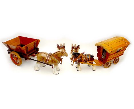 Two ceramic figurines, modelled as horses, one pulling a wooden cart, the other a caravan, together with a pair of ceramic bo