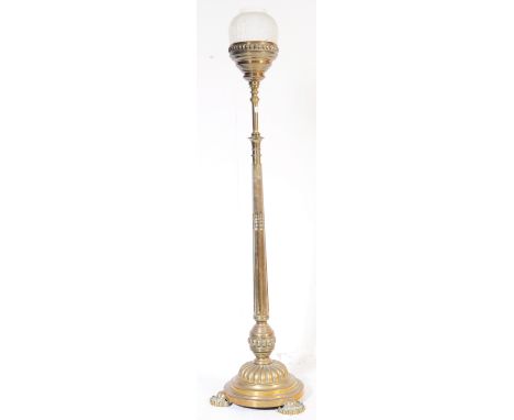 A 19th century Victorian floor standing oil lamp with shaped base and feet, tall column to reservoir, wick and frosted glass 