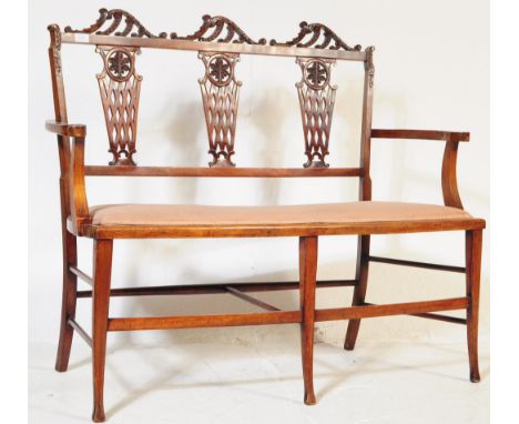 An Edwardian mahogany inlaid two seater sofa settee / salon sofa. The sofa having a triple pierced gallery vase backrest with