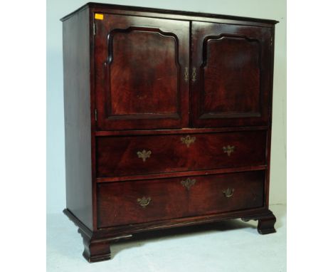 An 18th century revival oak cocktail drinks cabinet. The cabinet having twin door cupboard fielded panel of armorial form ove