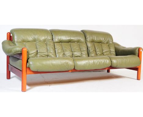 A vintage mid-century 3 seater sofa in green leather and mahogany in the style of Jean Gillon. Green leather removable cushio