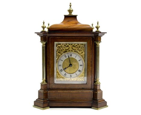 An Edwardian mahogany bracket clock, circa 1910, the case of Baroque architectural form with a cupola, brass pillars and fini
