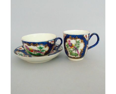 A Worcester  trio of tea cup, coffee cup and saucer,         decorated with the ‘Fancy Birds’ pattern on a scale blue ground,