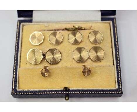 A Gents 9ct gold dress stud set comprising a pair of chain cufflinks, four large and two small button studs of octagonal shap
