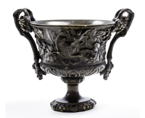 A 19th Century bronze campana vase, twin vine handles, the frieze with a fox pursuing a goat in high relief, socle, all-over 