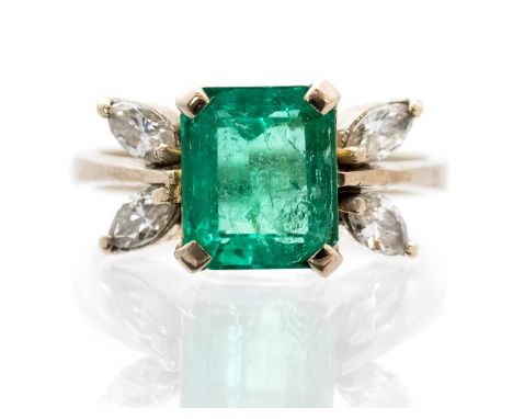 An emerald single stone white gold ring with diamond set leaf design shoulders, the emerald cut emerald approx  8.7mm by 7.3m