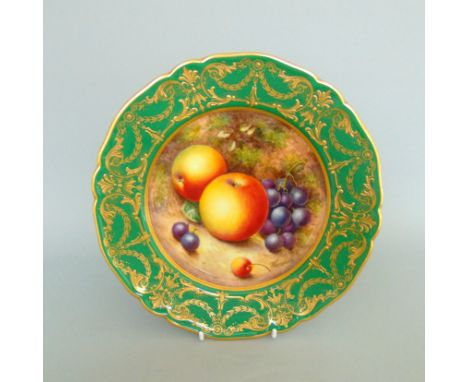 A Royal Worcester plate painted with fruit under a green and gilt ground, signed  John Freeman, date coded for  196022cm diam