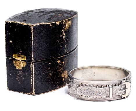 A Victorian silver bangle, cast and applied buckle form with chased foliate decoration, in fitted box, Jackson Brothers, Birm